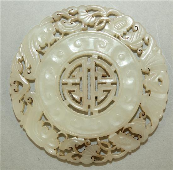 A Chinese pale celadon jade disc, 5.8cm